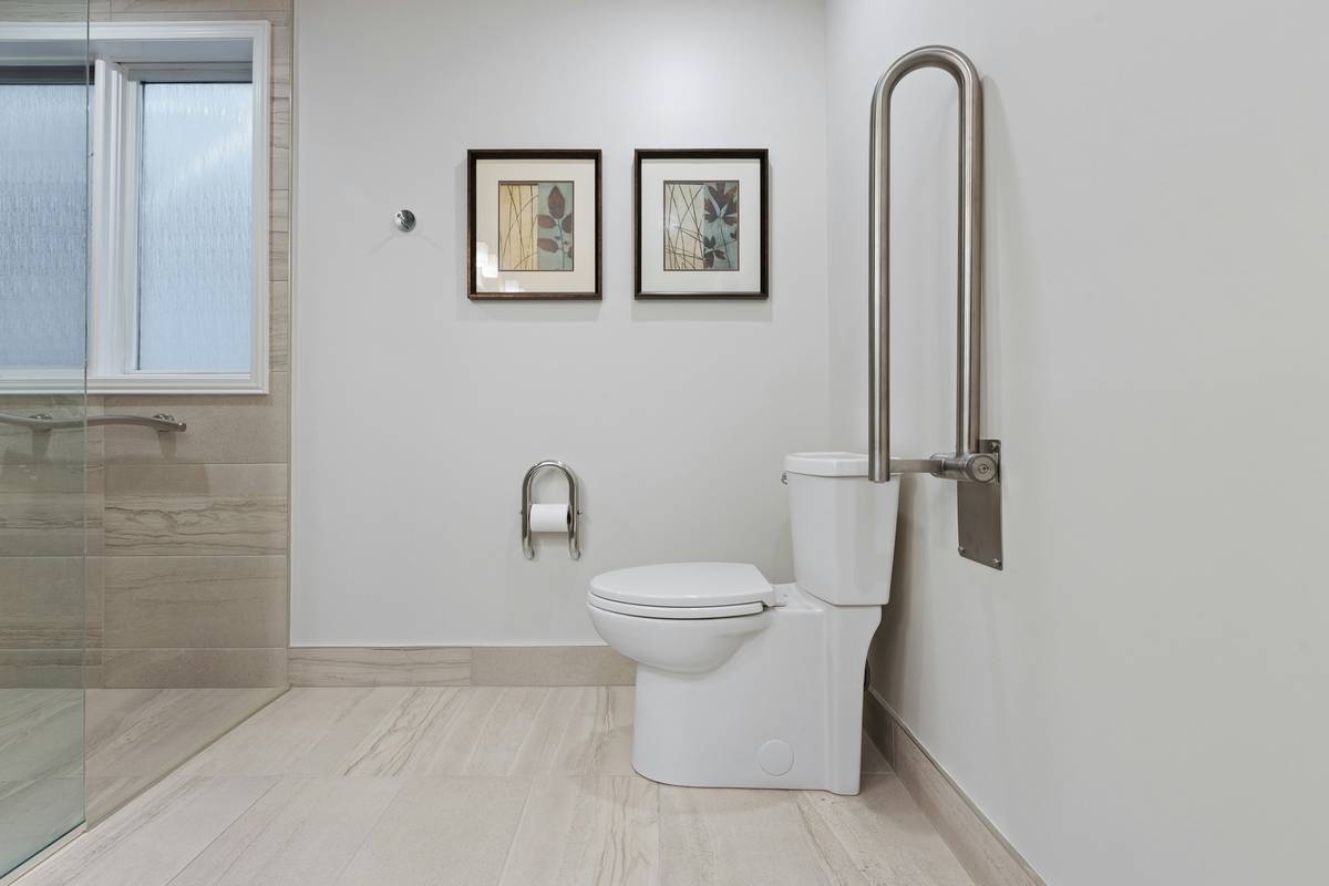safety step walk in tub with low-entry threshold and grab bars installed in a senior-friendly bathroom