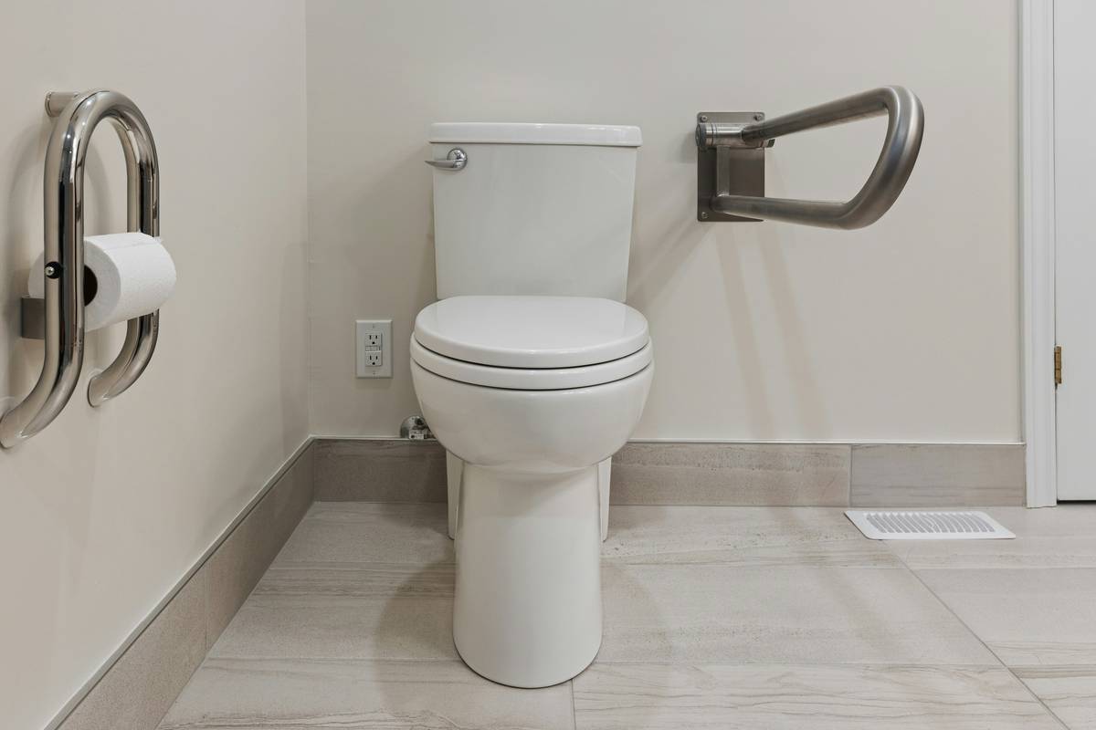Elderly woman safely entering a safety bath walk in tubs with grab bar support