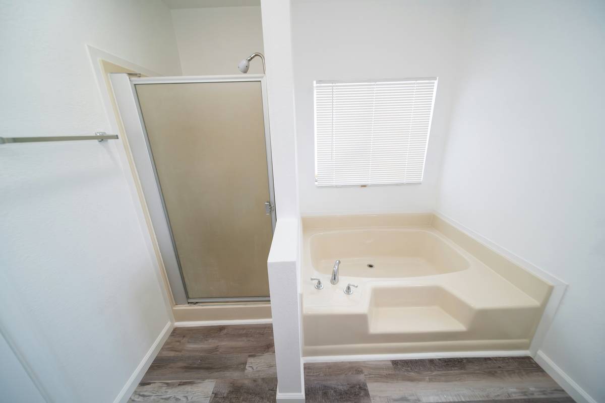 walk in bathtub bathroom with chrome fixtures and non-slip base